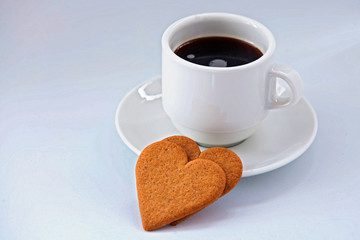 coffee cup with coffee on white background with heart shaped cookies