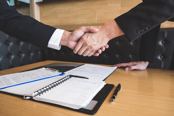 Successful job interview with boss and employee shaking hands after negotiation or interview, career and placement concept