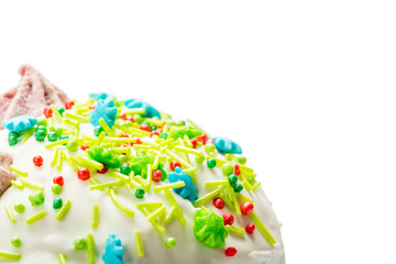 Top part of Easter cake with cream, colorful sugar sticks and drops