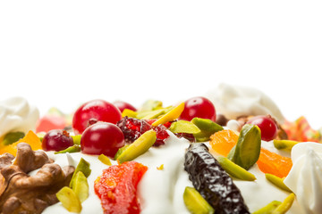 Top part of Easter cake with cream, cranberries, nuts and dried fruits
