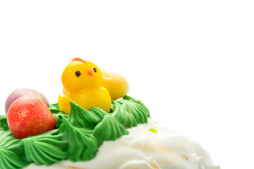 Top part of Easter cake with cream and funny chick.