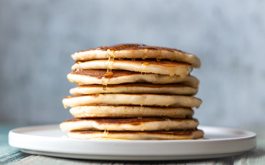Stack of pancakes with honey. Tasty breakfast.