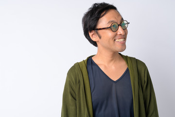 Portrait of happy Japanese man thinking against white background