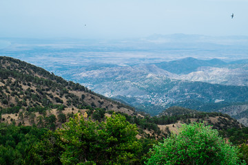 Troodos National Forest Park. Cyprus. Mountains covered forest on blue sky background. Top view. Tourist destination, tourism, travel, caravanning