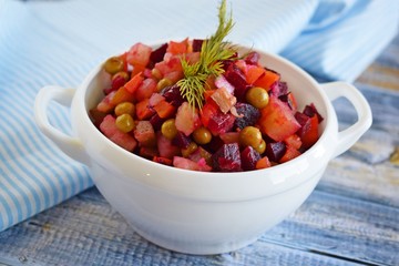 Vegetable salad with carrots and beets.Vinaigrette on a white plate.Vegetarian food.
