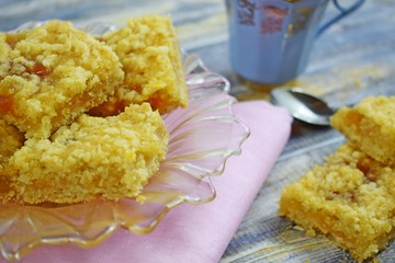 Homemade cookies with apricot jam on top, sprinkled with crumbs.