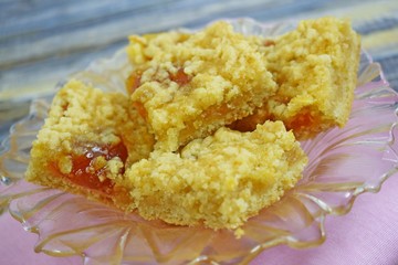 Homemade cookies with apricot jam on top, sprinkled with crumbs.