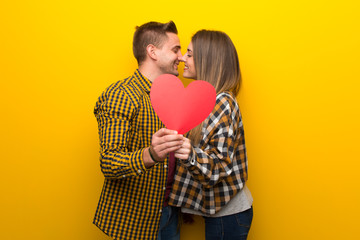 Couple in valentine day holding a heart symbol