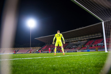 Football game at the Stadium in night. Goalkeeper and game © kovop58