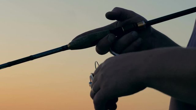 Modern rod with a spinning equipment, close up.