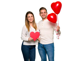 Couple in valentine day holding a heart symbol and balloons