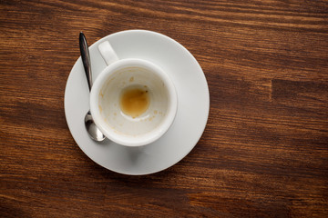 Empty coffee cup after drink on wood table. Top view