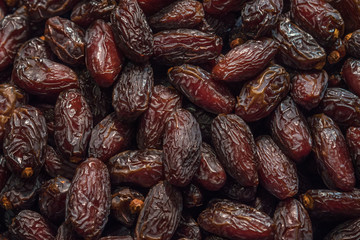 Close up food background of dried dates dark expressive texture, close up