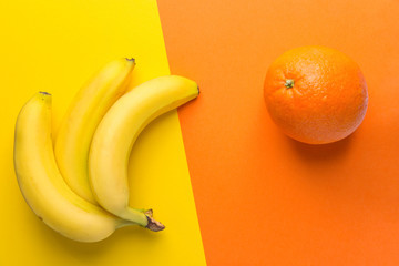 Bunch of yellow ripe bananas orange on duotone background. Creative trendy flat lay. Healthy food clean eating balanced diet superfoods concept. Copy space - Powered by Adobe
