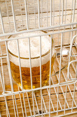 Glass of beer in a cage