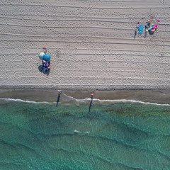 Aerial top view on the La Manga beach. Umbrellas, traces on the sand and turquoise mediterranean sea