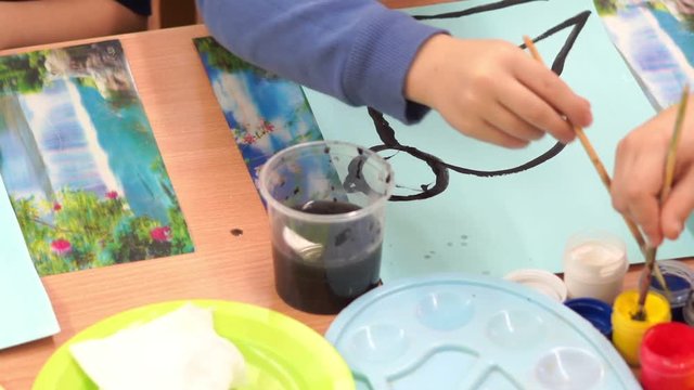 preschool education - children in kindergarten paint colors of winter birds