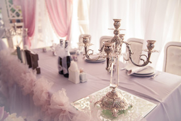 luxury candlestick on the table, the decor of the wedding table. Romantic dinner. Valentine's Day