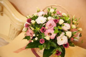 Beautiful basket of flowers on a shelf in the bedroom, close-up