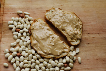 Delicious peanut butter sandwich breakfast and peanut on wooden table background. Sweet food, breakfast concept