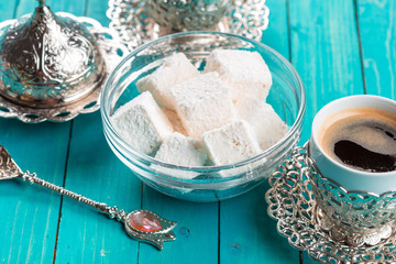 Traditional turkish coffee and turkish delight on wooden background.