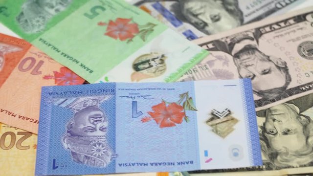 US dollar and Malaysia money on the table rotating. 4K