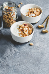 Breakfast bowls with organic granola, nuts, coconut chips and greek yoghurt.