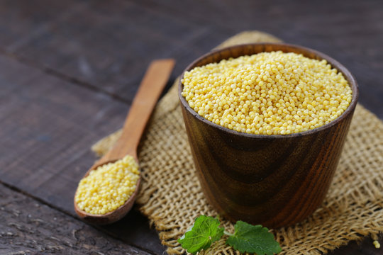 millet groats in a wooden cup, healthy food