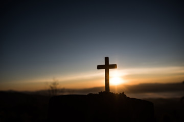 Silhouette of catholic cross and sunrise - obrazy, fototapety, plakaty