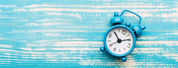 clock, alarm clock on a blue vintage background, copy space, banner