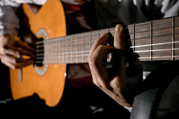 Guitarist hands and guitar close up. Playing classic guitar. Play the guitar.