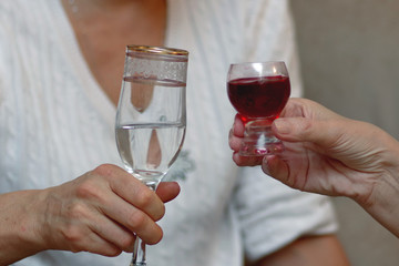 people clinking their glasses to drink to health and happiness