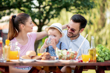 Family enjoying outdoor meal at home