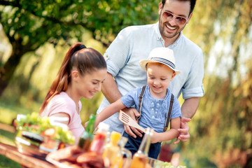Happy family having lunch outdoors