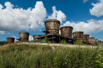 Old rusty cooling towers against a blue sky