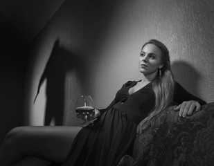 Young  beautiful woman and the culprit shadow on the wall.