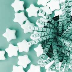  festive composition of marshmallow stars and cocktail straws in a glass, top view.
