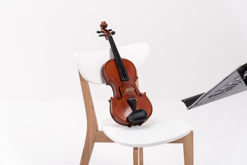Violin ,note stand put on chair at school or practice room ,During the practice break time to prepare For the concert.