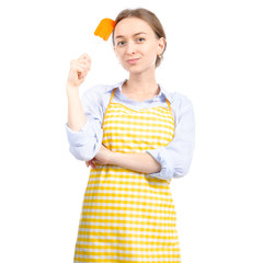 Woman in yellow apron with kitchen spatula in hand on white background isolation