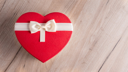 red heart gift box on wooden background. Valentine's day