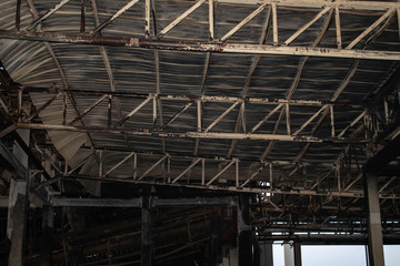 Old building black soot stains ruins and old roof structure rusted and steel frame that collapsed because of the fire.