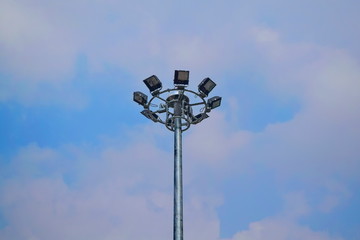 Pole mounted light bulb spotlight with a lot of background sky.