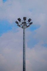 Pole mounted light bulb spotlight with a lot of background sky.