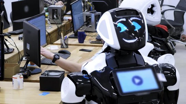 Factory for the production of robots. The engineer examines the robot. Creates new robots in the lab. Configures disassembled robot.