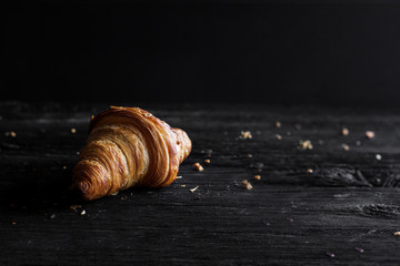 Fresh croissant on wooden background
