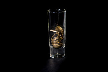Glass for alcohol with Euro coins. 