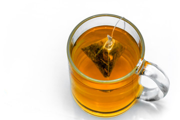 Glass cup with teabag, black tea. Isolated on a white
