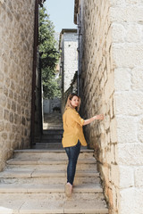 girl walks on the street of the old European city. Travels. Sights. Life style. Montenegro Perast