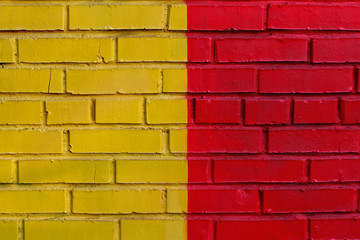 Colorful (yellow and red) brick wall as background, texture