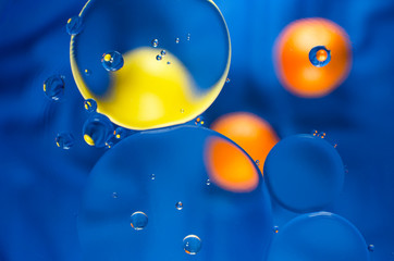 circles of Mandarin and yellow on a dark blue background with blue circles